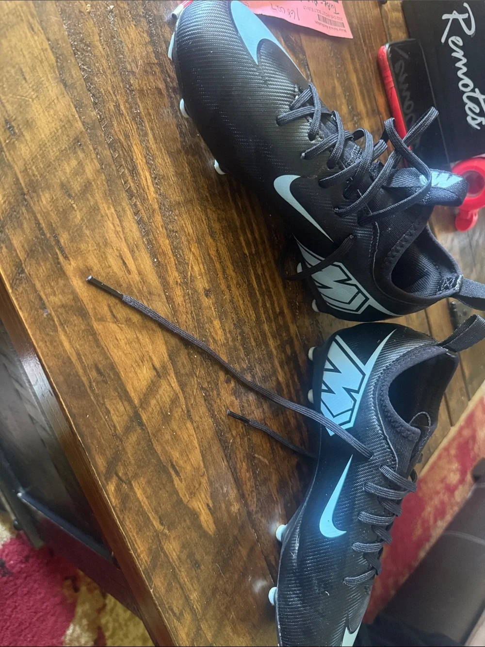 Nike Black Cleats with Light Blue Swoosh